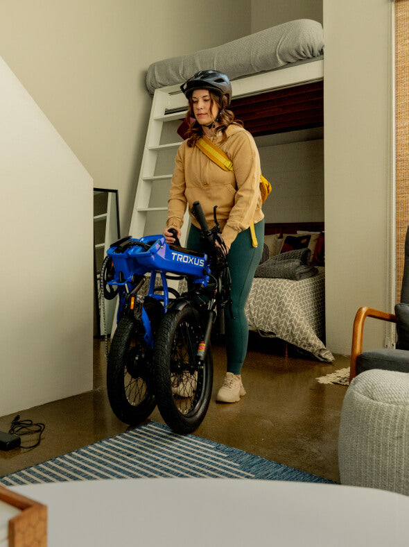 woman-takes-lynx-folding-ebike-from-small-space